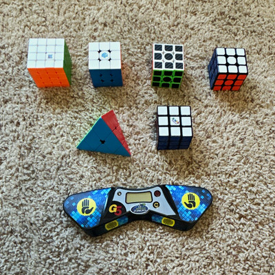 Rubik s cube set includes 4 3x3, 1 pyramid, 1 4x4, and a timer.