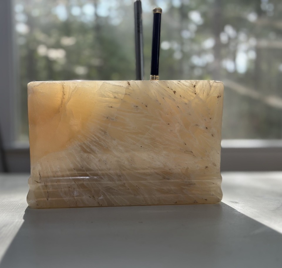 Solid hand-carved onyx with a striking sunburst pattern — a genuine stone desk piece that's heavy, sculptural, and impossible to ignore.