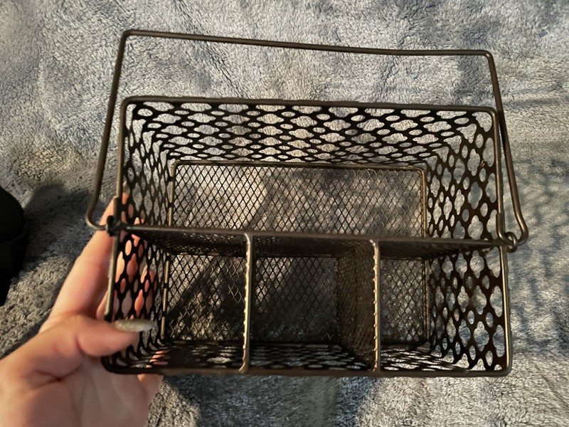 dark bronze metal mesh utensil caddy with a carry handle