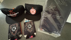 Orange county soccer club autographed hats and banner