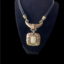 Door knocker style silvertone statement necklace with leather strap