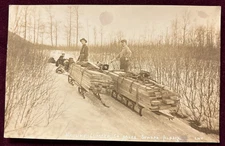 1910 RPPC Hauling Lumber Sled Dogs Seward Alaska Occupational Photo Postcard UNP
