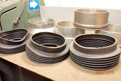 PILE OF MOORE JIG GRINDER SPINDLE RUBBER BOOTS AND COLLARS