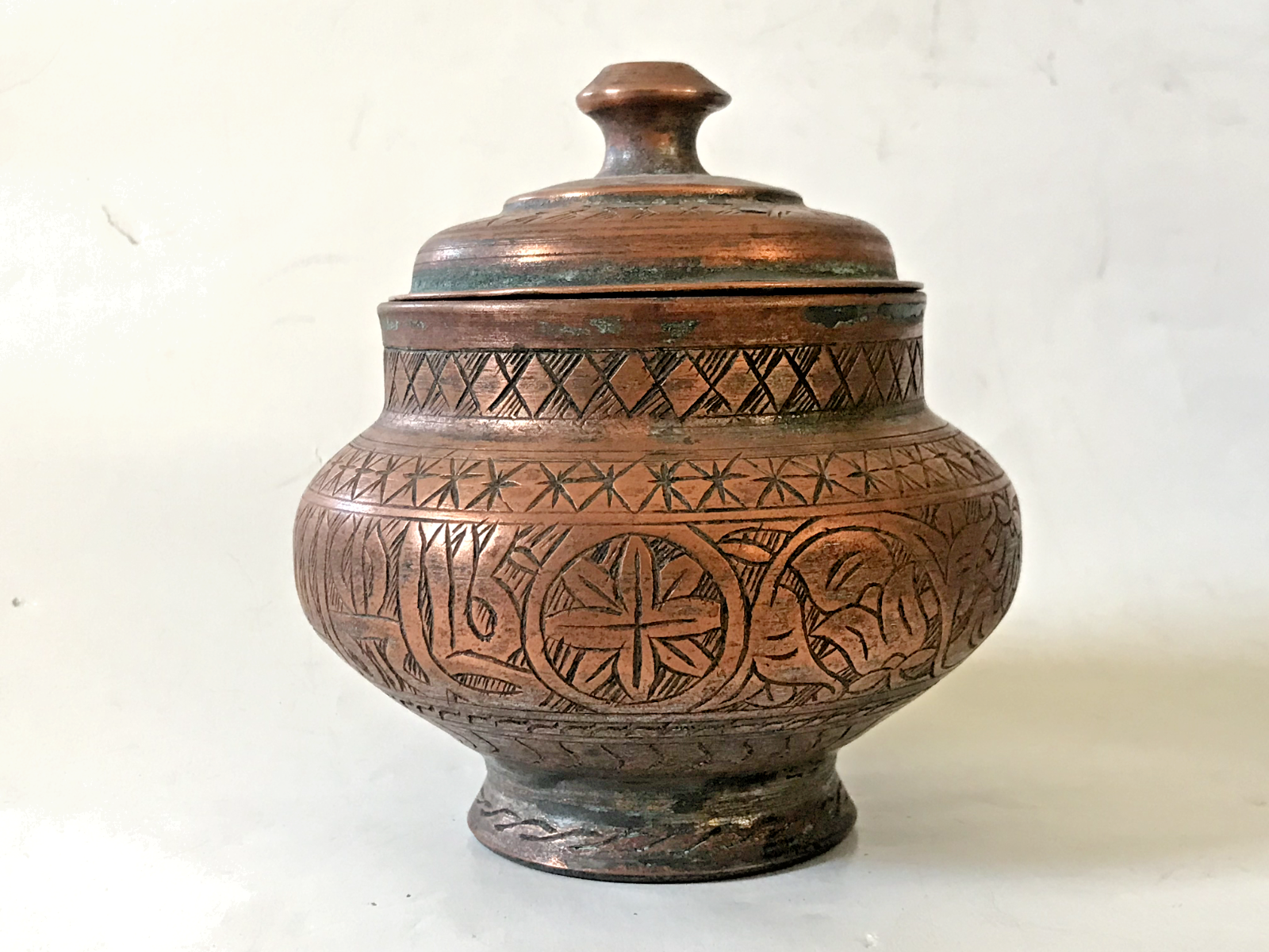 Antique Middle-eastern pot with islamic inscriptions and arabic calligraphy .