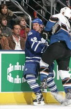 Kyle Wellwood Toronto Maple Leafs braces for the hit from Be- Ice Hockey Photo
