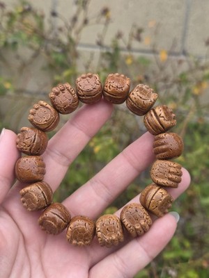 Seize Your Power: The 16mm Artisan-Carved Peach Pit Fist Bracelet