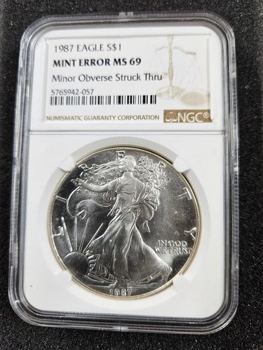 🌟 1987 American .999 Silver Eagle Minor Obverse Struck Thru Error NGC MS69 Coin
