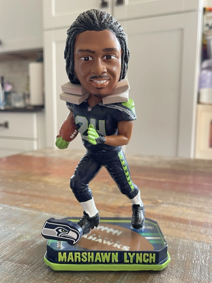 Modo Bestia MARSHAWN LYNCH Seattle Seahawks NFL Springy Logo Bobblehead ¡NUEVO EN CAJA! Foto 2 de 2