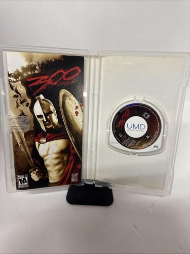 PSP case for “300: March to Glory” showing Spartan warrior with sword and shield, along with loose UMD disc.