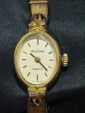 Bulova Quartz Gold Tone Oval Dress Watch Champagne Dial Base Metal Bracelet