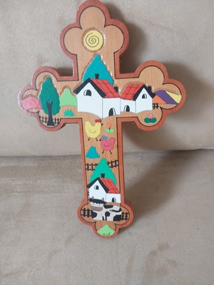  a cross, featuring a folk art style depiction of a farm scene. 