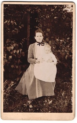 Photograph Young Mother in Striped Dress with Child on Lap in Garden,  