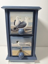 small wooden chest of drawers featuring nautical-themed artwork of seagulls