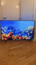 Samsung 58" RU7100 Series 4K Ultra HD Smart TV with a FREE TV stand