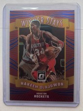 2023-24 Panini Donruss Optic Hakeem Olajuwon #12 Winner Stays Blue 7/85 Rockets