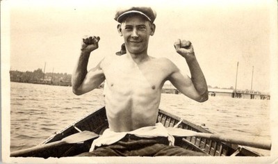 1910s-30s Shirtless Man Flexing in Rowboat - Newsboy Cap & Oars - Photograph