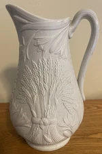 White Stoneware or Ceramic (?) Pitcher with Wheat Design on Two Sides 8.25” Tall