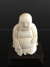 ANTIQUE HAND CARVED SEATING BUDDHA FIGURINE ON WOOD STAND 2 INCHES TALL