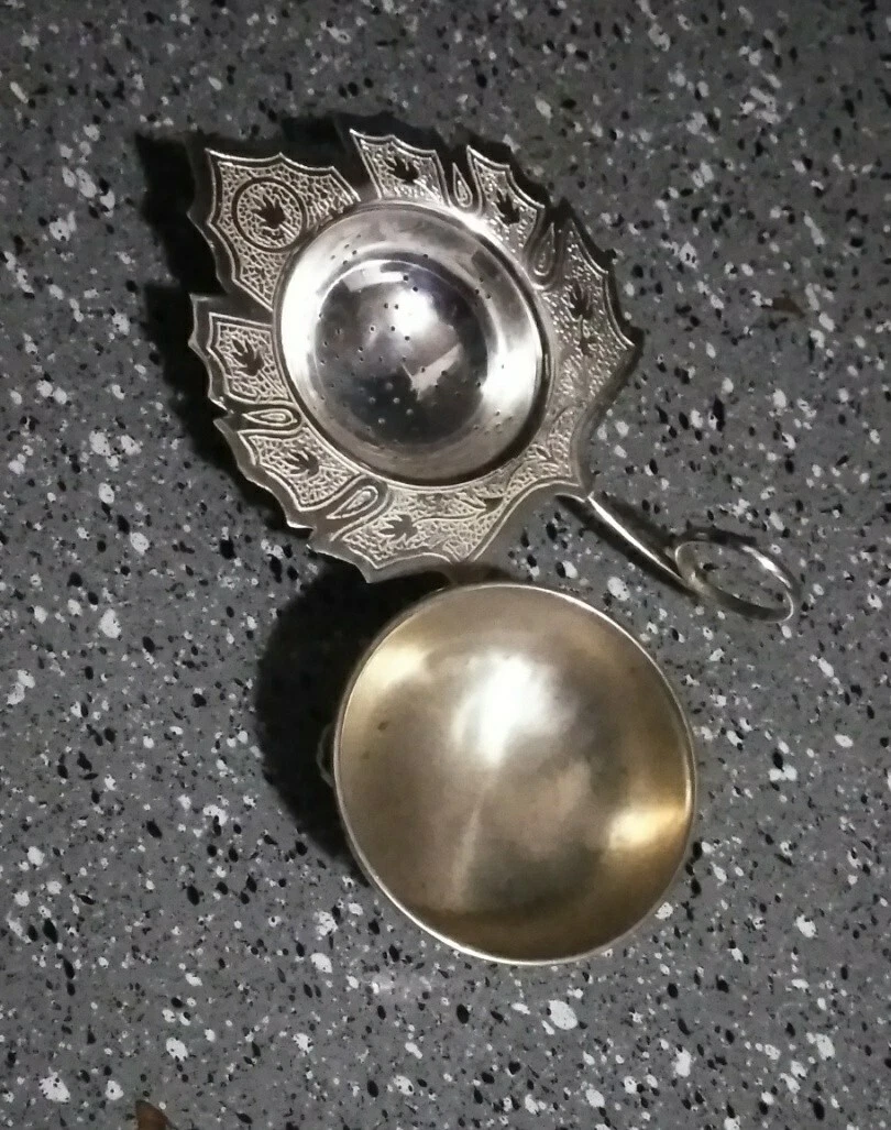 India Silver Pierced Loose Leaf Tea Strainer with a bowl