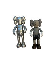 KAWS Companion Like vinyl art toy figure in a metallic silver/grey color 4”