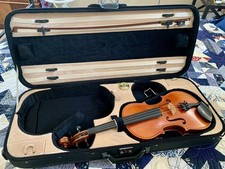 Violin with detailed scroll work in double case