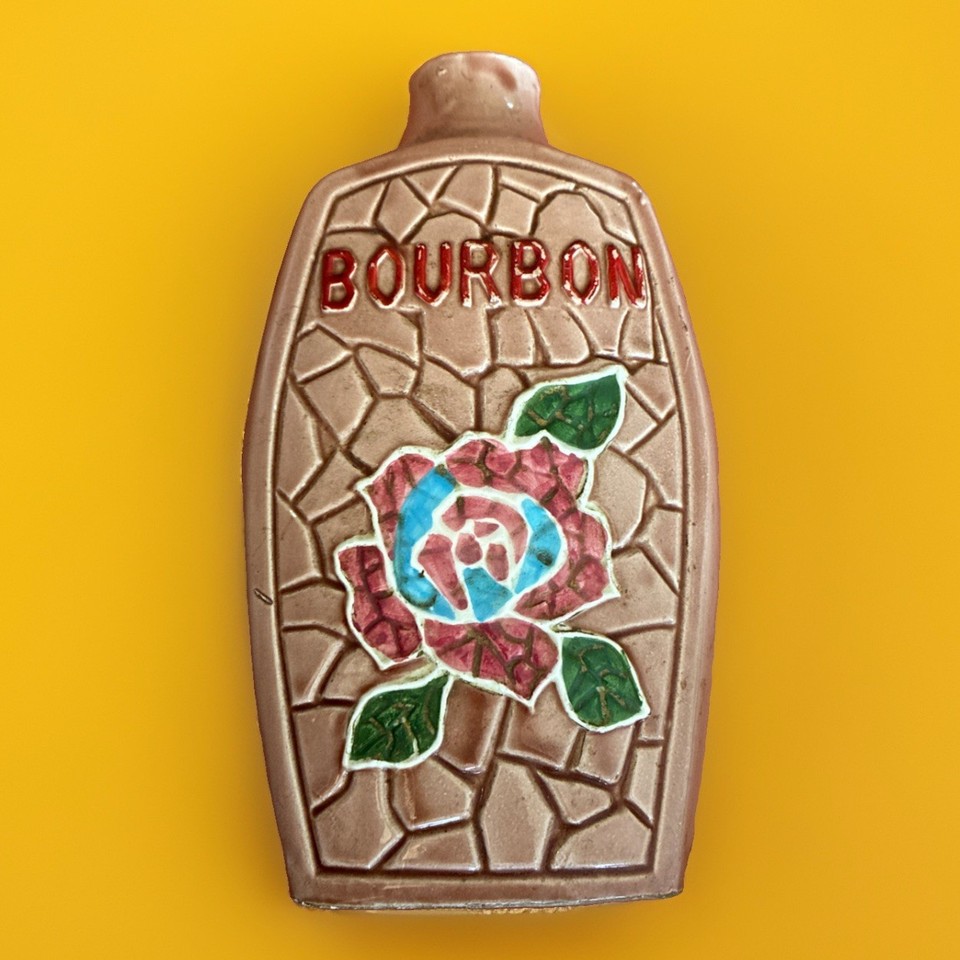 Hand-painted mid-century Japanese ceramic bourbon decanter shaped like a quirky girl — the kind of kitsch barware that stops guests mid-pour.