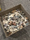 Open box with multiple pieces of vintage Built Rite Indian Summer puzzle, some with metallic silver and blue designs.