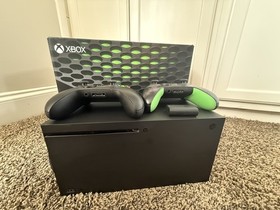 Microsoft Xbox Series X 1TB Console with two Microsoft controllers, battery pack