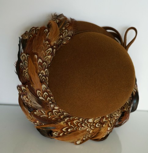 Brown hat with 100% wool EXCELLO crown, featuring tan and brown pheasant feathers with blue, red, and yellow accents.