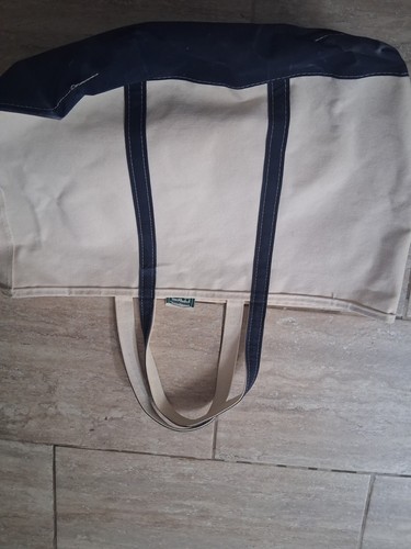 LL Bean navy blue canvas tote bag with matching top and sides, featuring small white LL Bean logo patch on front.