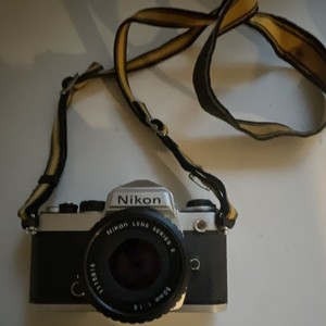 Nikon FM Silver 35mm SLR Film Camera with Series E 50mm f/1.8 Lens Strap