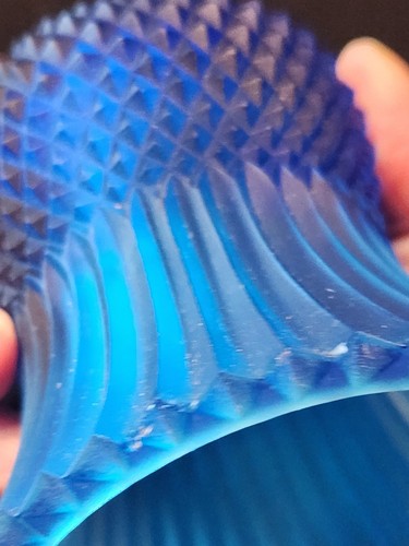 Close-up of cobalt blue glass tulip votive candle holder with textured diamond-patterned sides and base, made in the USA.