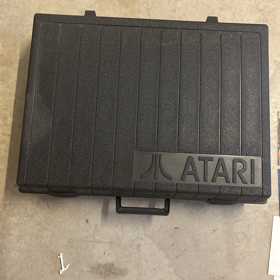 An original OEM Atari 2600 hard-shell carrying case — a display-worthy 80s artifact that doubles as quirky storage for any retro collector.