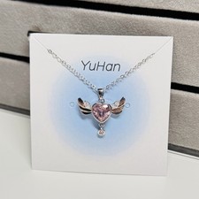 Sparkling pink heart and wing pendant adjustable 18" stainless steel necklace.