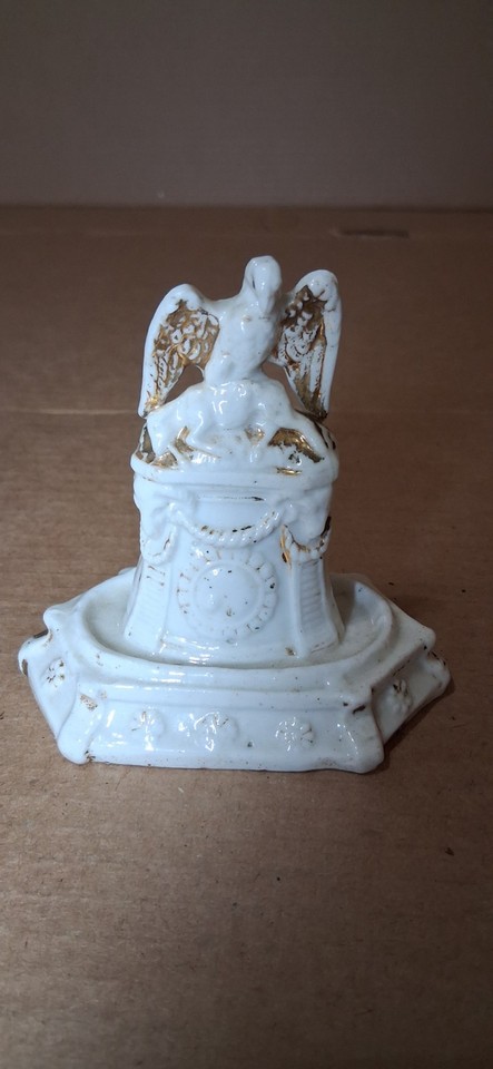 A Victorian Staffordshire porcelain eagle pocket watch stand — an ornate, museum-worthy desk piece that doubles as a working clock display.