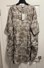Gray linen long sleeve dress with subtle textured pattern, round neckline, and front pockets, hanging on black hanger.