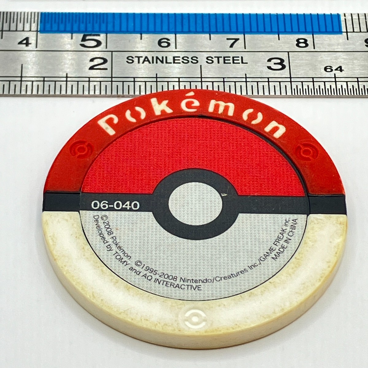 Stunky - Pokemon Arcade Game Token 06-040 Tag Coin TOMY 2008
