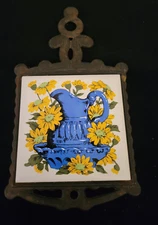 Vintage Ceramic Cast Iron Metal Trivet 9.5" long Blue Pitcher w/ yellow daisies