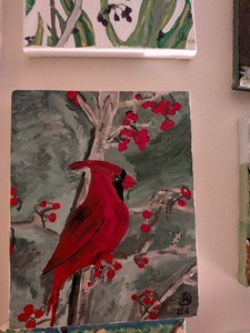 A CARDINAL ON A BERRY BUSH