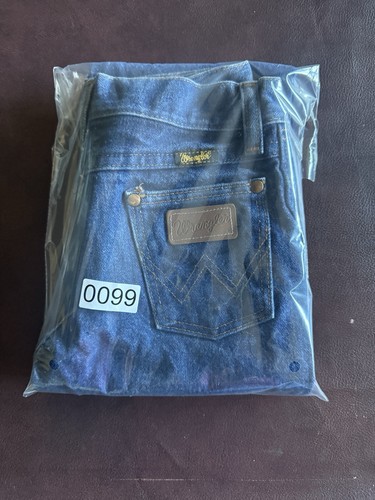 VTG 1989 kids’ Wrangler blue jeans, size 7, with back pocket and brown leather Wrangler patch, in clear plastic packaging.