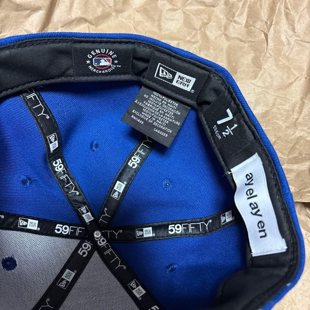 Blue New Era x ay el ay en Los Angeles Dodgers cap with gray star graphic on front and black brim patch with white text.