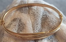 9ct Gold Bangle with clear stones. 6.10g