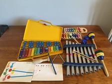 Large collection of children's xylophones, maracas, and musical instruments