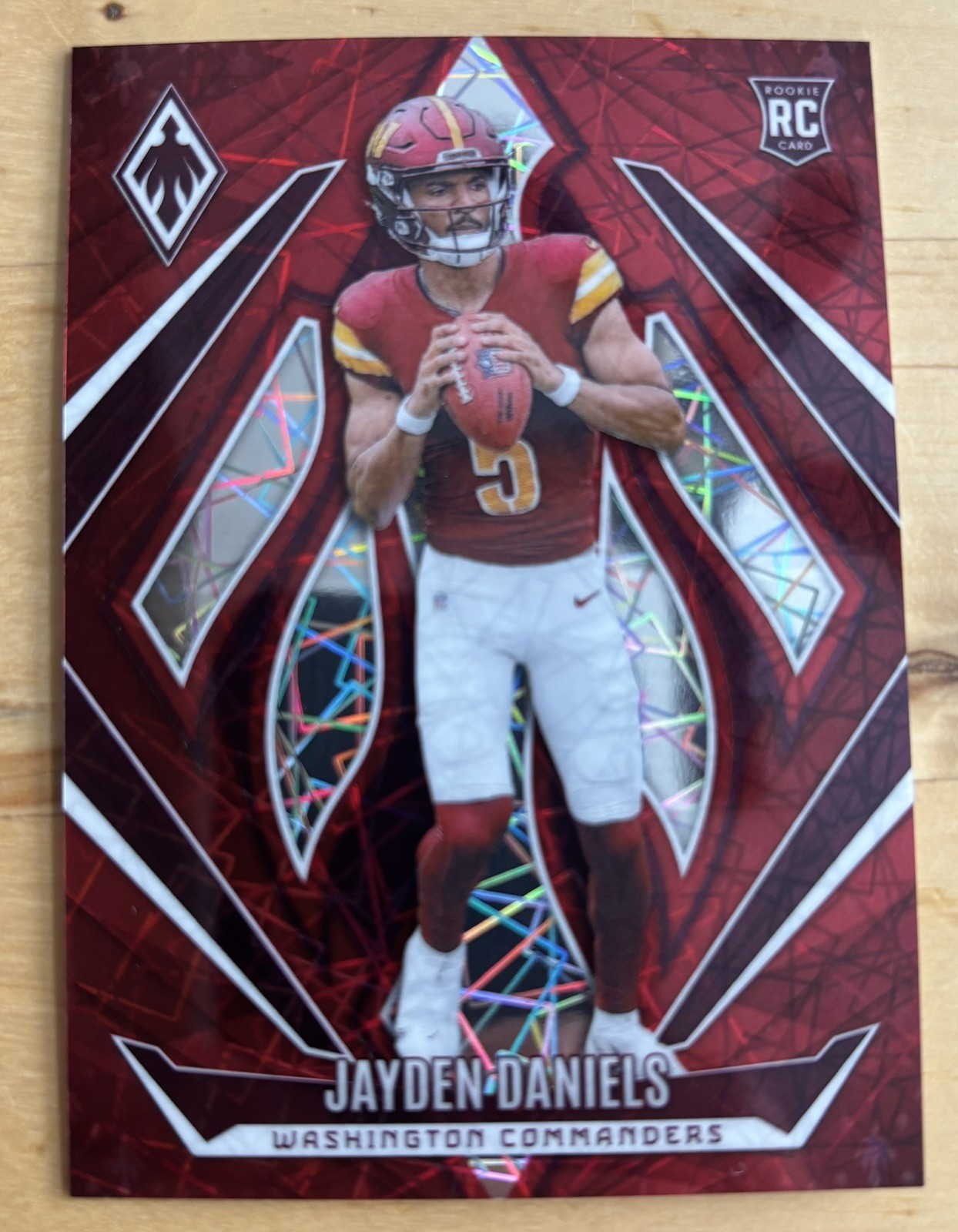 2024 Panini Phoenix - Rookies Jayden Daniels #198 Red Lazer /199 (RC)