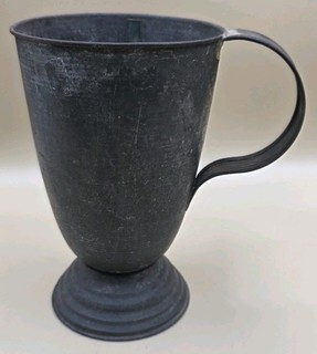 A vintage pewter cup with a handle and pedestal base. Glad's Disher