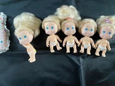 Quints dolls, sleeping bag, bottles & rattles