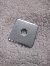 Square heavy duty steel washer. 2 In x2 In, 1/5 Inch thick. 1/2 inch hole
