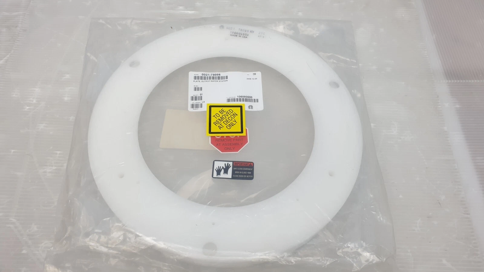White AMAT 0021-78086 output plate in inner bag with decon and assembly-only labels