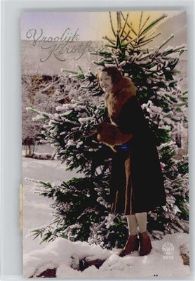 12015520 - Fur Fashion - Glamour Woman Getting a Christmas Tree Out of the Woods -