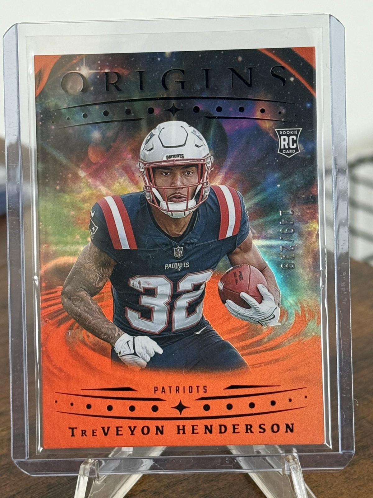 2025 Panini Origins TreVeyon Henderson RC Holo Orange /249 NE Patriots #105